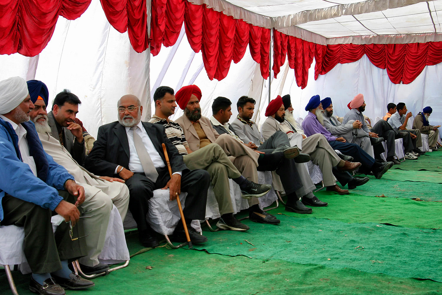 Men sitting at wedding party Punjab